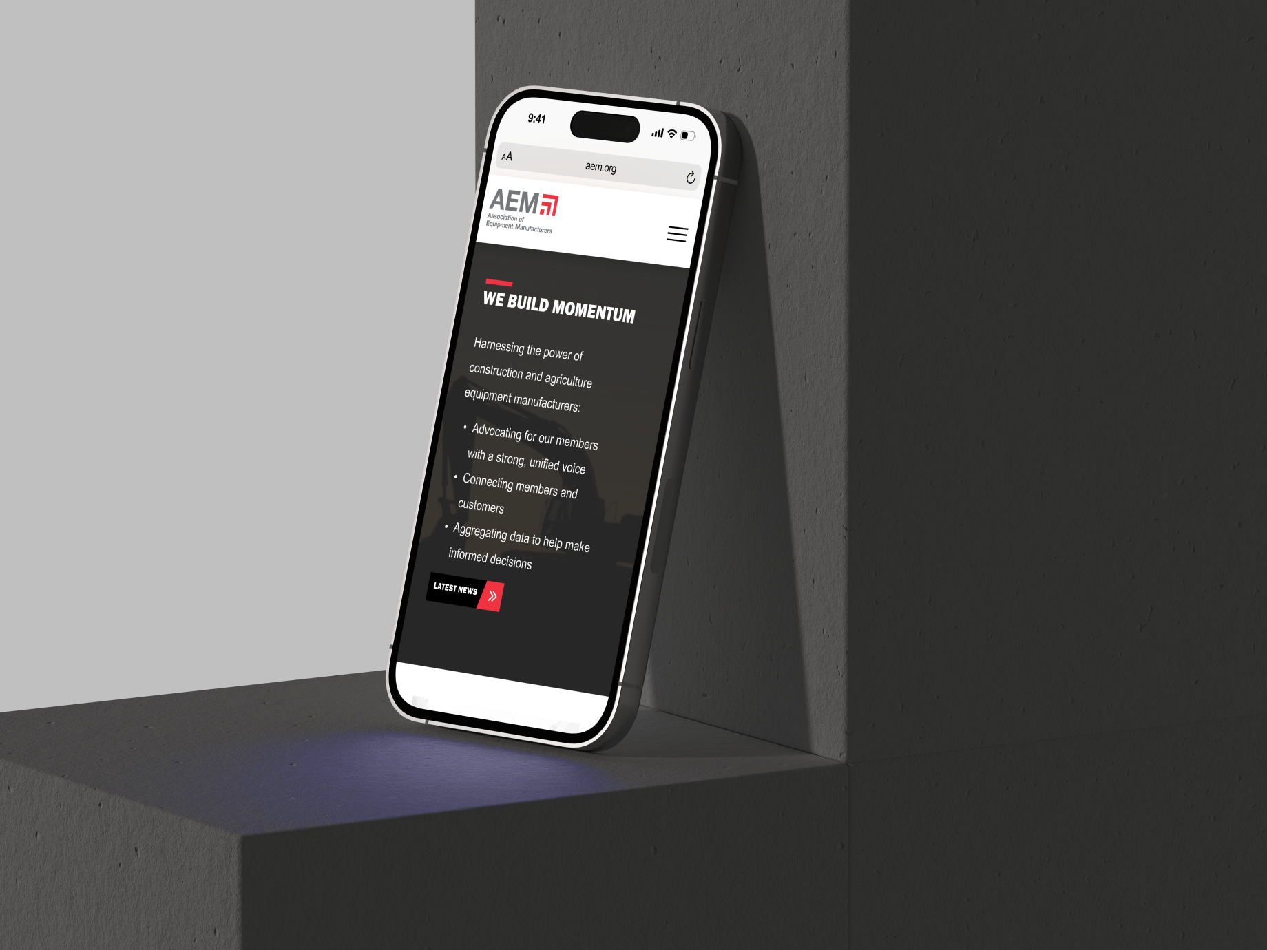 Photo of AEM.org homepage, as seen on a mobile cell phone