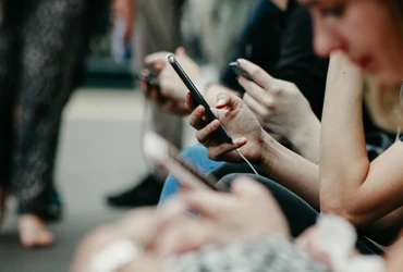 Abstract image of people looking at their phones